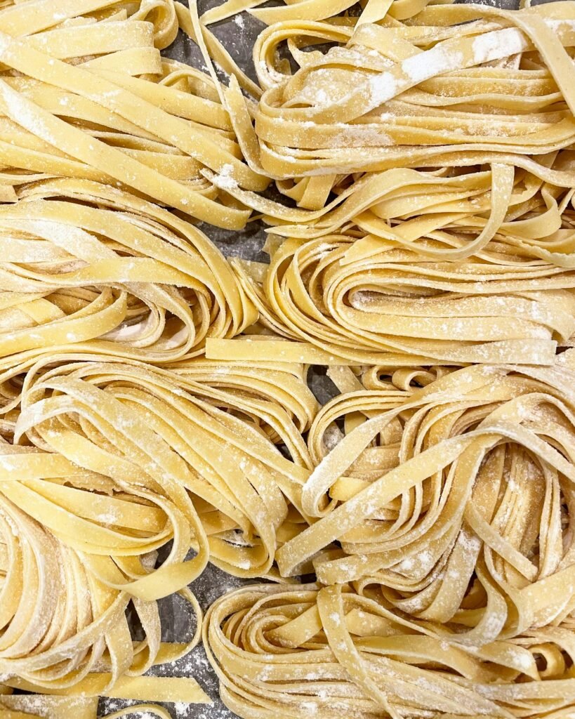 yellow pasta on stainless steel tray